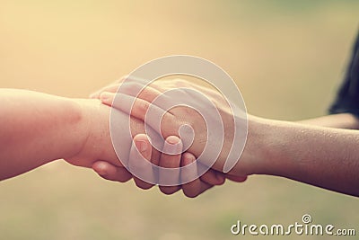 people old and young hand holding with sunset Stock Photo