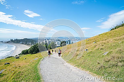 People outdoors taking morning walk up slope Mount Maunganui Editorial Stock Photo