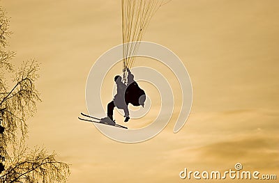 People on paraplane at sunset Stock Photo