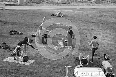 People in park by the beach doing yoga Editorial Stock Photo