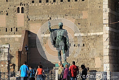 People passing by the Caesar monument in historical center. Editorial Stock Photo