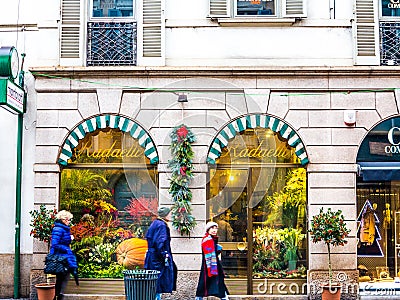 People passing by a flower shop Editorial Stock Photo