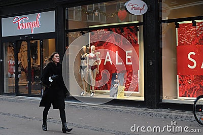 PEOPLE PAST BY SALE SIGN IN TUMPH LINGERIE STORE Editorial Stock Photo