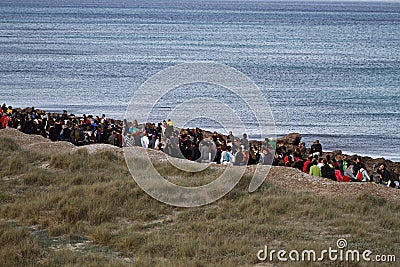 People in a peaceful demonstration on a beach to protect it from construction Editorial Stock Photo