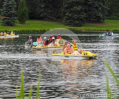 People In Peddle Boats On Small Lake Editorial Stock Photo