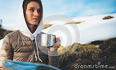 People planning trip in snow mountain, girl hold in hands cup of drinks, relax tourist look on map, hipster enjoy on background Stock Photo