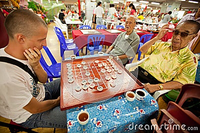 People play Chinese chess in Chinatown Bangkok. Editorial Stock Photo