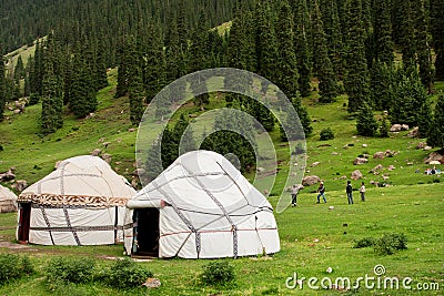 People play games outdoor near the asian farmers houses Yurts in Central Asian mountains Editorial Stock Photo