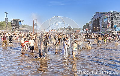 People playing in mud during 21th Woodstock Festival Poland. Editorial Stock Photo