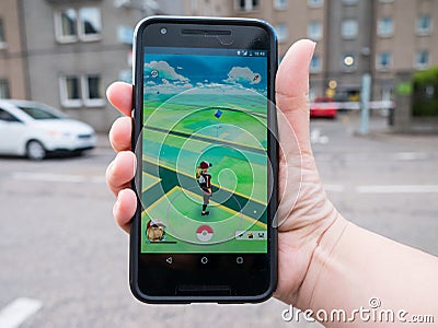 People playing Pokemon GO the hit augmented reality smart phone app Editorial Stock Photo