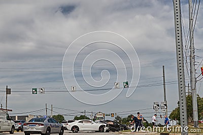 People and Police officer at a wreck white Camero Editorial Stock Photo