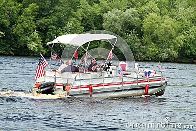 People on pontoon in parade on the river to celebrate Independence Day, the Fourth of July Stock Photo