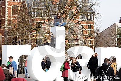 People posing for photo on the letters of writing, I amsterdam, Museumplein, Rijksmuseum, Holland Editorial Stock Photo