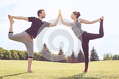 People practice acro yoga outdoors healthy lifestyle Stock Photo