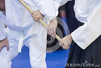 People practice Aikido with wooden jo Stock Photo