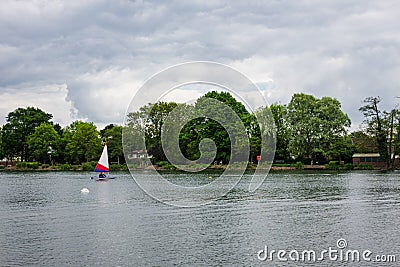 People practice sailing on a Spring day in South Norwood lake Stock Photo