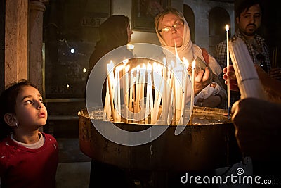 People pray in church and put candles Editorial Stock Photo