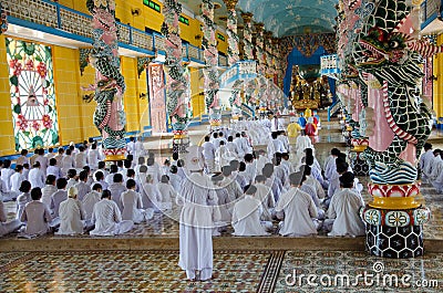 People praying in Cao Dai Temple in Vietnam Editorial Stock Photo