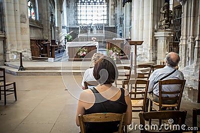 People praying inside a church Editorial Stock Photo