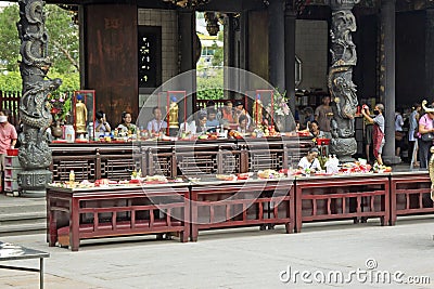 People praying in Mengjia Longshan Temple in Taipei Editorial Stock Photo