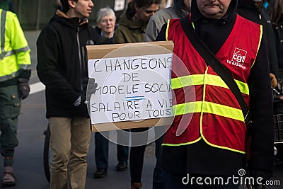 People protesting in the street with placard in french : changeons de modele socail, in Editorial Stock Photo