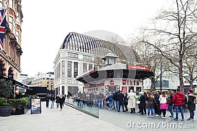 People queue for buying tickets from TKTS, the official London theatre ticket booth located at Leicester Square Editorial Stock Photo