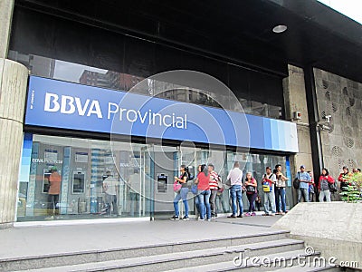 People queuing to withdraw money from ATMs of the BBVA Provincial Bank, at its headquarters Editorial Stock Photo