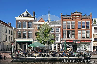 People recreating on sunny boat terrace in Leiden Editorial Stock Photo