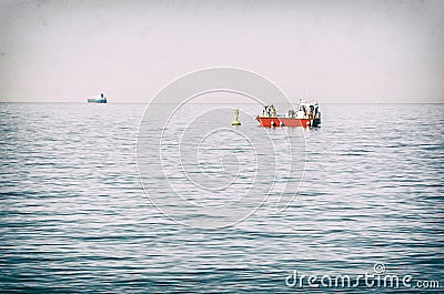 People on red boat, Gulf of Trieste, analog filter Stock Photo