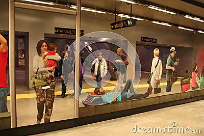 NAPLES, ITALY, November 2016 People are reflected in a spectacular mirror with silhouettes of travelers in Metro station Editorial Stock Photo