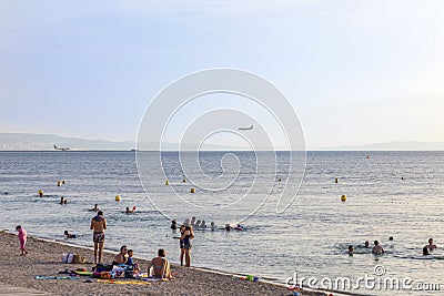 People relax at the beach in front of Marseille provence Airport Editorial Stock Photo