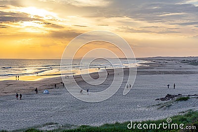 People relaxing on the Birubi beach at sunset. Stock Photo
