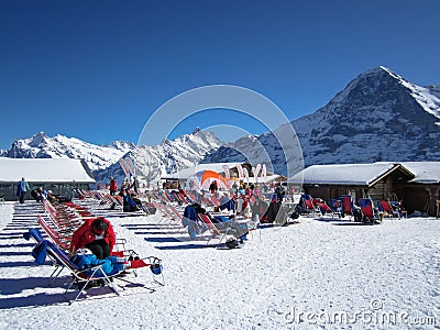 People relaxing and enjoying the sun after skiing on MÃ¤nnlichen, Jungraujoch ski region, Switzerland, Europe Editorial Stock Photo