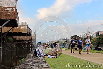 People relaxing in Kamo river. Its riverbanks are popular walking spots for residents and tourists. Editorial Stock Photo