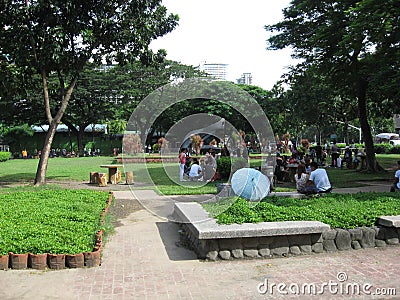 People relaxing in Rizal park, Manila, Philippines Editorial Stock Photo