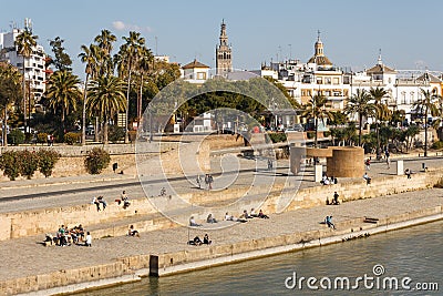 People relaxing at waterfront in Sevilla Editorial Stock Photo