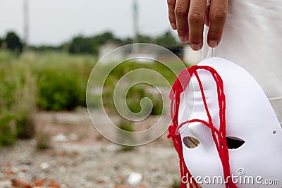People releases the white mask and red wool. Stock Photo