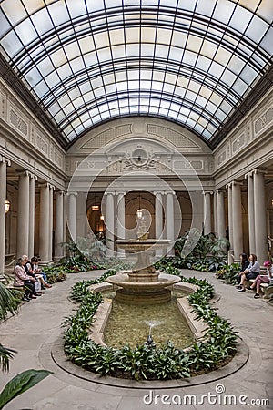 people rest in the atrium of the Frick Collection, former 5th Avenue mansion of steel magnate Henry Clay Frick Editorial Stock Photo