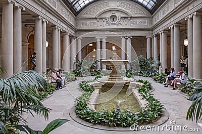 people rest in the atrium of the Frick Collection, former 5th Avenue mansion of steel magnate Henry Clay Frick Editorial Stock Photo