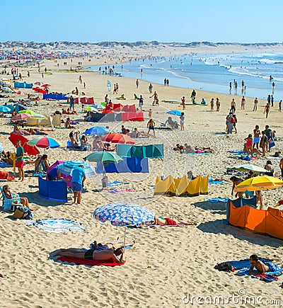 People rest ocean beach. Portugal Editorial Stock Photo