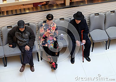 People resting in luxury shopping mall interior in Shanghai Editorial Stock Photo