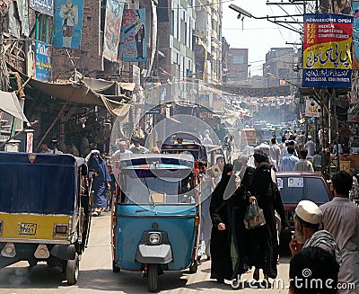 People and rickshaws in a busy street in Peshawar, Pakistan Editorial Stock Photo