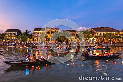 People ride boats and release lanterns at Thu Bon River Editorial Stock Photo