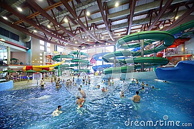 People ride on chutes and swim in pool Editorial Stock Photo