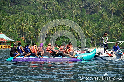 People riding banana boats on the beach on vacation Editorial Stock Photo