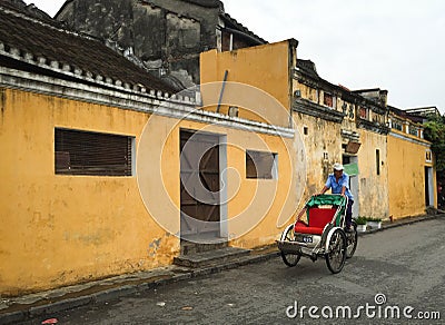 People riding cyclo on street in Hoi an, Vietnam Editorial Stock Photo