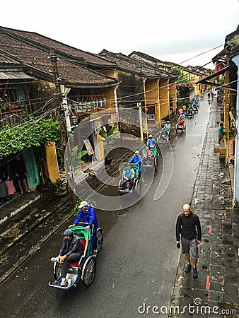 People riding cyclos on main road at Ancient town in Hoi an, Vietnam Editorial Stock Photo