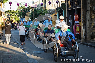 People riding cyclos on street in Hoi An, Vietnam Editorial Stock Photo