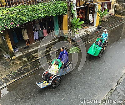 People riding cyclos on street in Hoi An, Vietnam Editorial Stock Photo