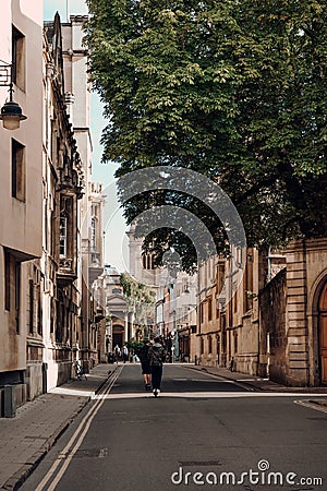 People riding electric scooters on a street in Oxford, UK Editorial Stock Photo